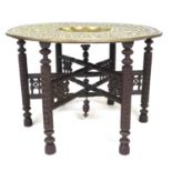 A South East Asian brass circular occasional Benares style table, embossed decoration with