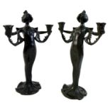 A pair of Secessionist or Art Nouveau bronze figural candelabrum, each modelled as a woman, with