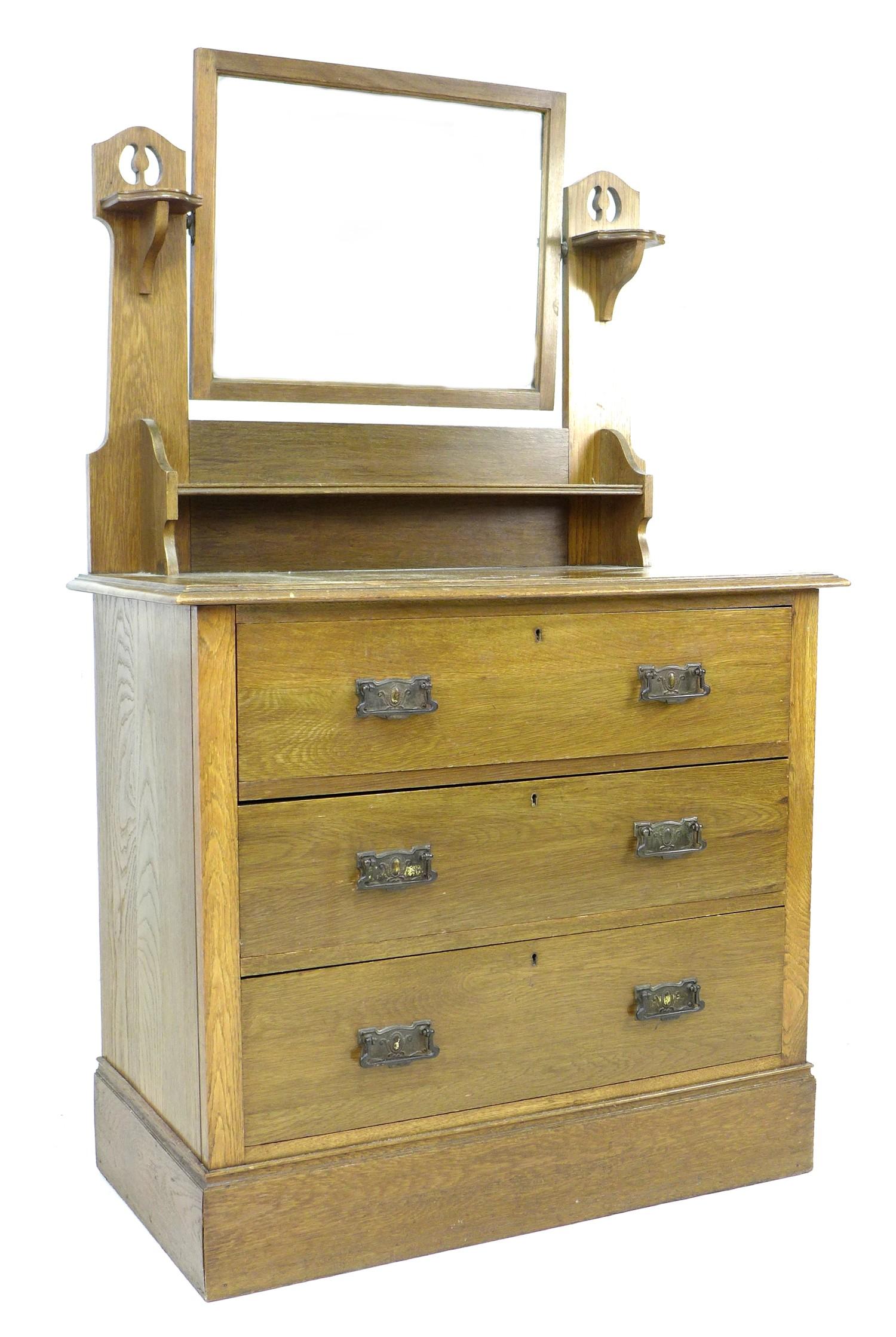 A Art Nouveau oak dressing chest, mirror over three drawers, 91.5 by 48 by 151cm high.