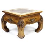 A modern Indonesian hardwood side table, square surface, cared floral decoration, short curved legs,