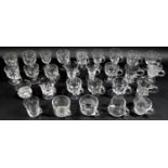 A collection of clear glass custard cups, jelly or syllabub cups, mostly Victorian and later,
