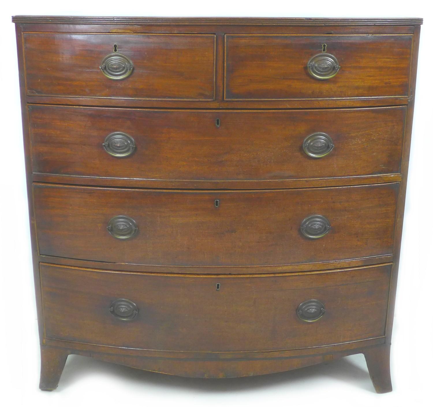 A Regency mahogany bow front chest of two over three graduated drawers, with cock beading and oval