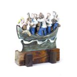 A Studio Pottery figural group, modelled as fishermen serenading a mermaid with guitars, in a boat