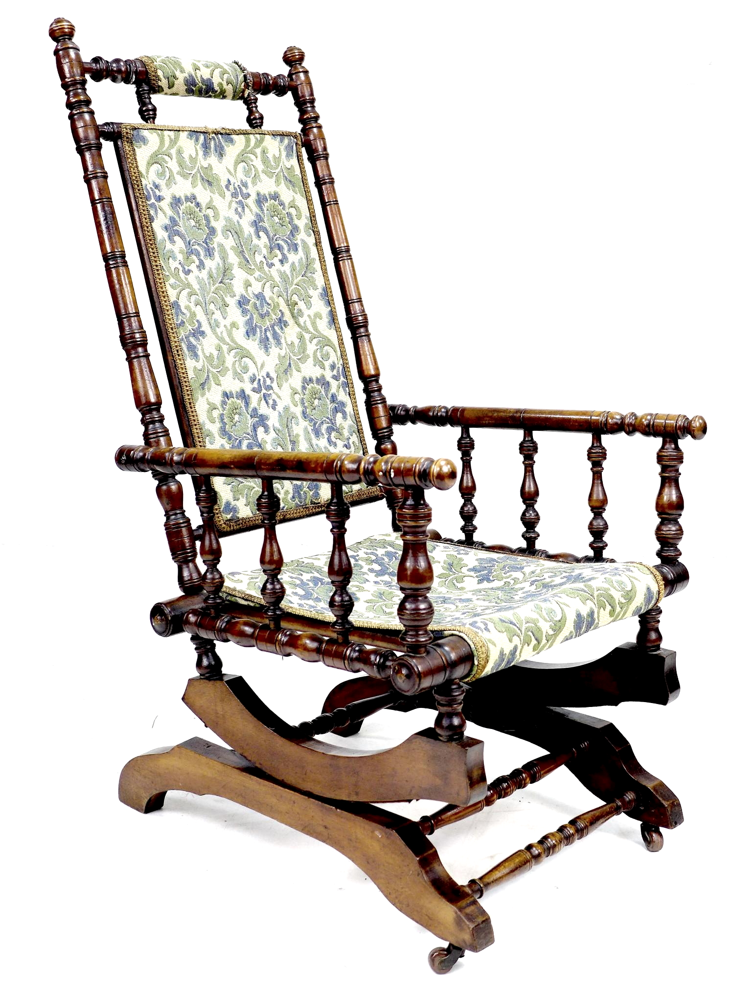 An American rocking chair, wooden turned spindle frame, metal sprung rocking action, floral