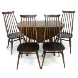 An Ercol circular drop leaf dining table, dark stained, circa 1970, 113 by 64 by 73cm high, together