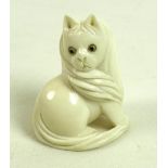 A Japanese ivory netsuke, Meiji period, circa 1900, carved as a cat sitting looking over it's