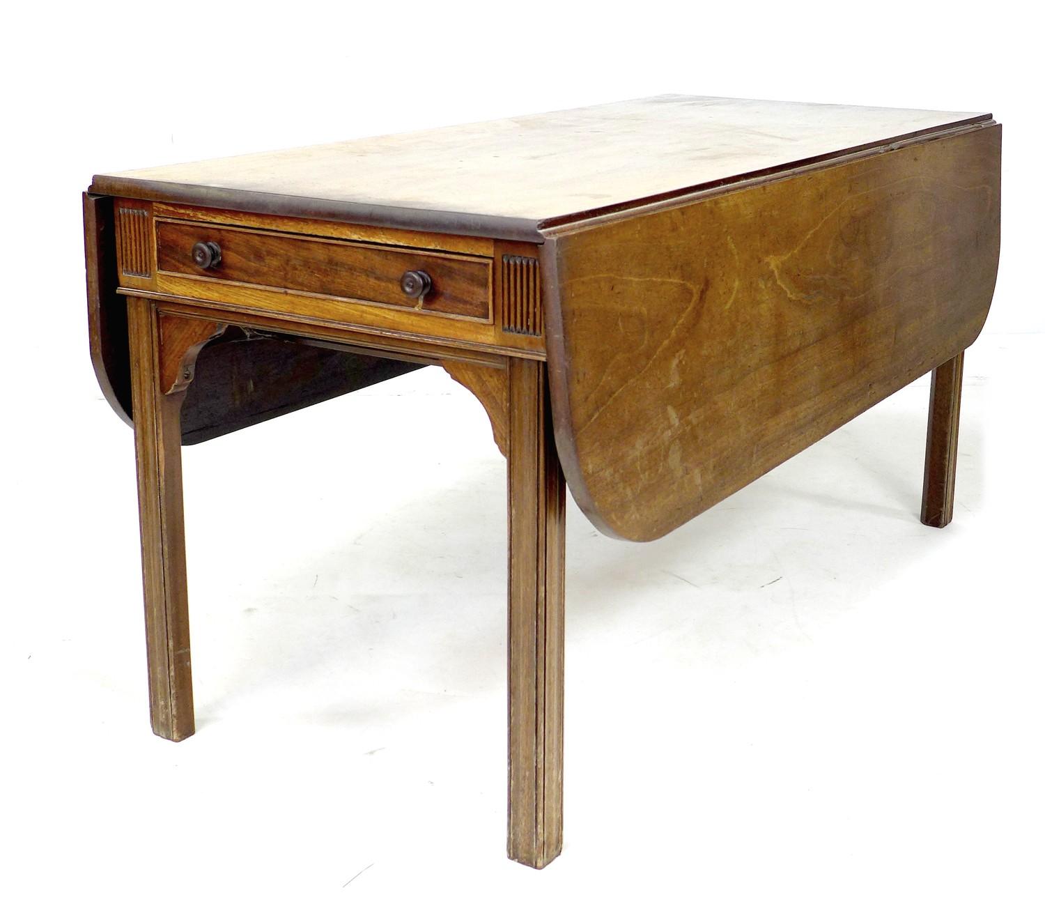 A George III mahogany drop leaf table, of long narrow form with single drawer, raised on