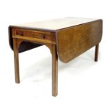 A George III mahogany drop leaf table, of long narrow form with single drawer, raised on