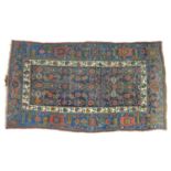 A Persian rug with dark blue ground, floral decoration all over, cream and light blue borders, 119