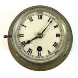 A WWII brass cased ship's clock, cream dial with black Roman numerals, folding glass cover, marked
