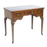 An Edwardian mahogany and satinwood inlaid writing desk, with a leather inlaid top above three