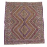A Gazak rug, with orange, purple and light green double diamond shaped decoration, latch hook edges,