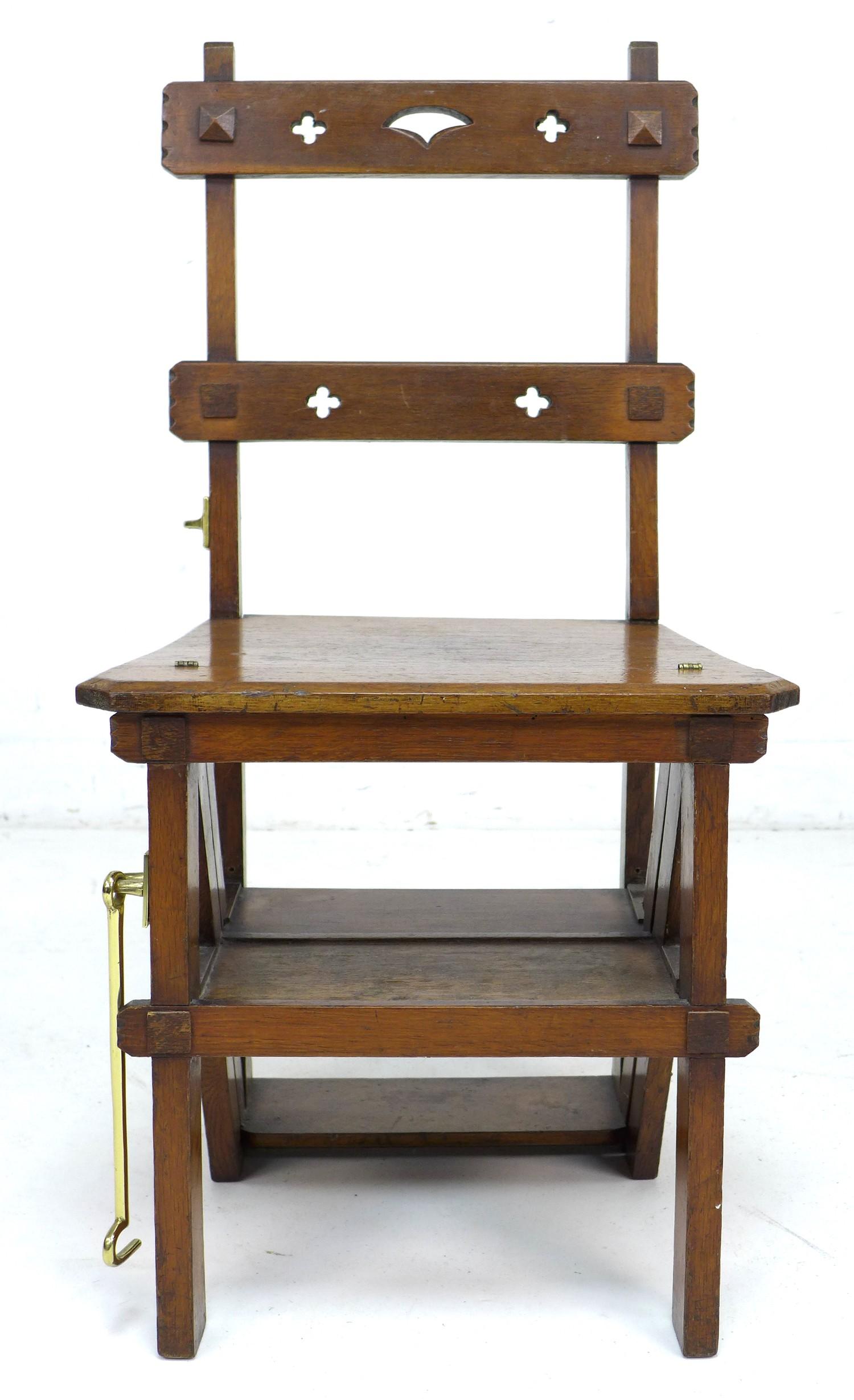 A set of oak metamorphic library steps, folding into a chair, the top rail with pierced quatrefoil - Image 3 of 10