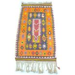 A woolen wall hanging rug, multicoloured geometric decoration in orange, black, grey and red, 170 by