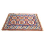 A Persian rug with red ground, six large cream, red, and blue hexagonal medallions to the field,
