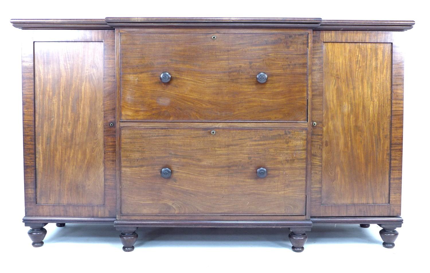 An early Victorian mahogany sideboard chest, of unusual form with two very deep central drawers with