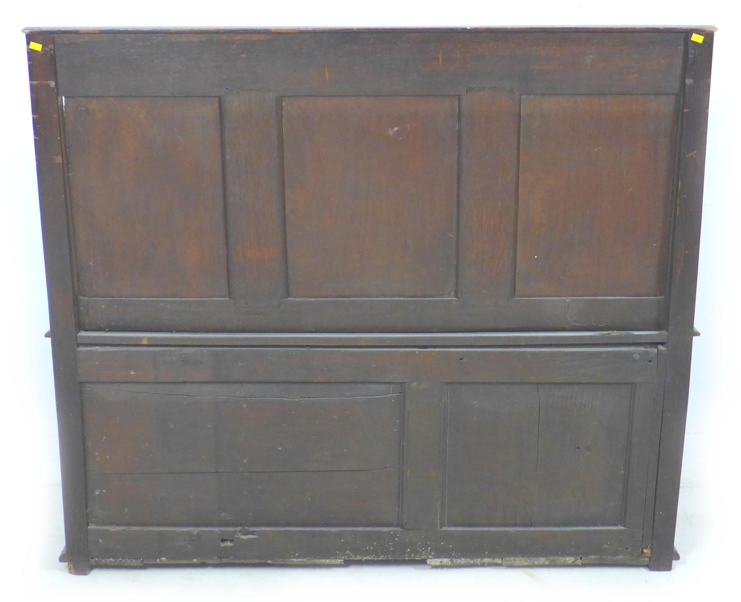 An 18th century oak settle, with carved frieze above a three panel carved back, open shaped - Image 8 of 8