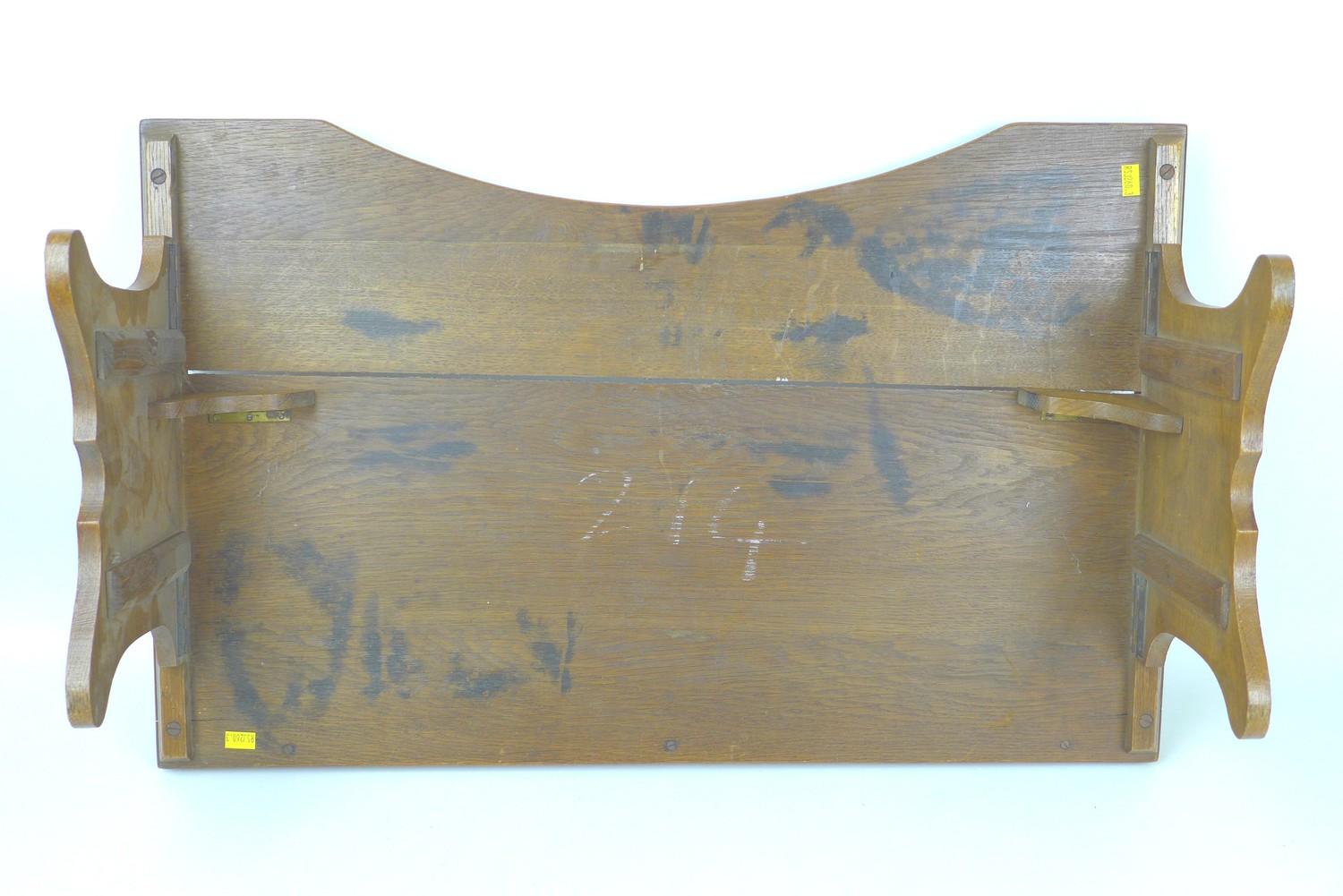 An early to mid 20th century oak bed tray, with folding legs, 68 by 43 by 24cm high, with legs down. - Image 4 of 5