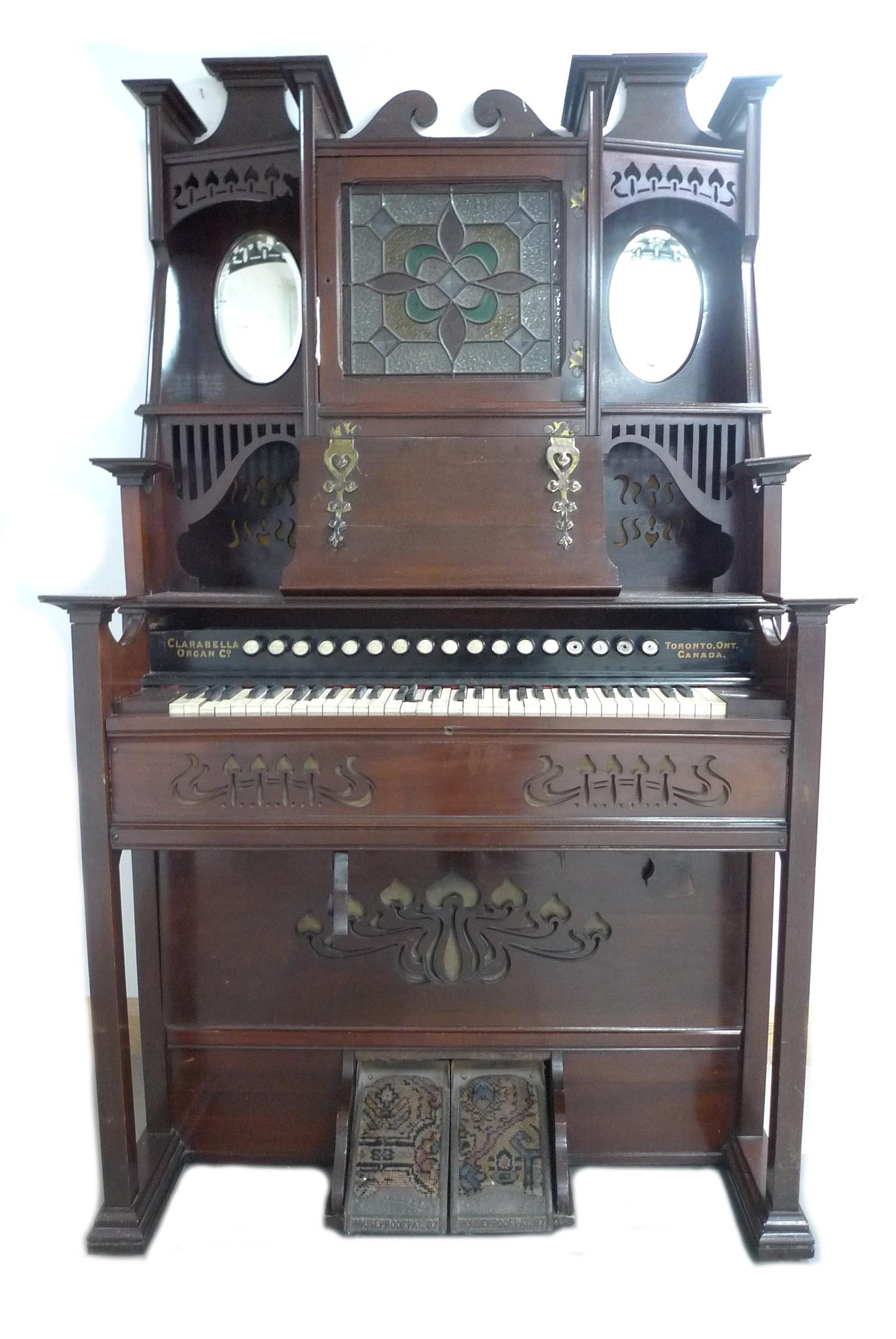 A late 19th century Canadian Clarabella harmonium, with mahogany case, a square form stained glass