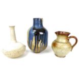 A group of studio pottery ceramics comprising a large vase of wide baluster form, slip glazed with
