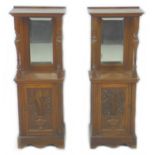 A pair of late 19th / early 20th century French oak cabinets, each with a top shelf with bevelled