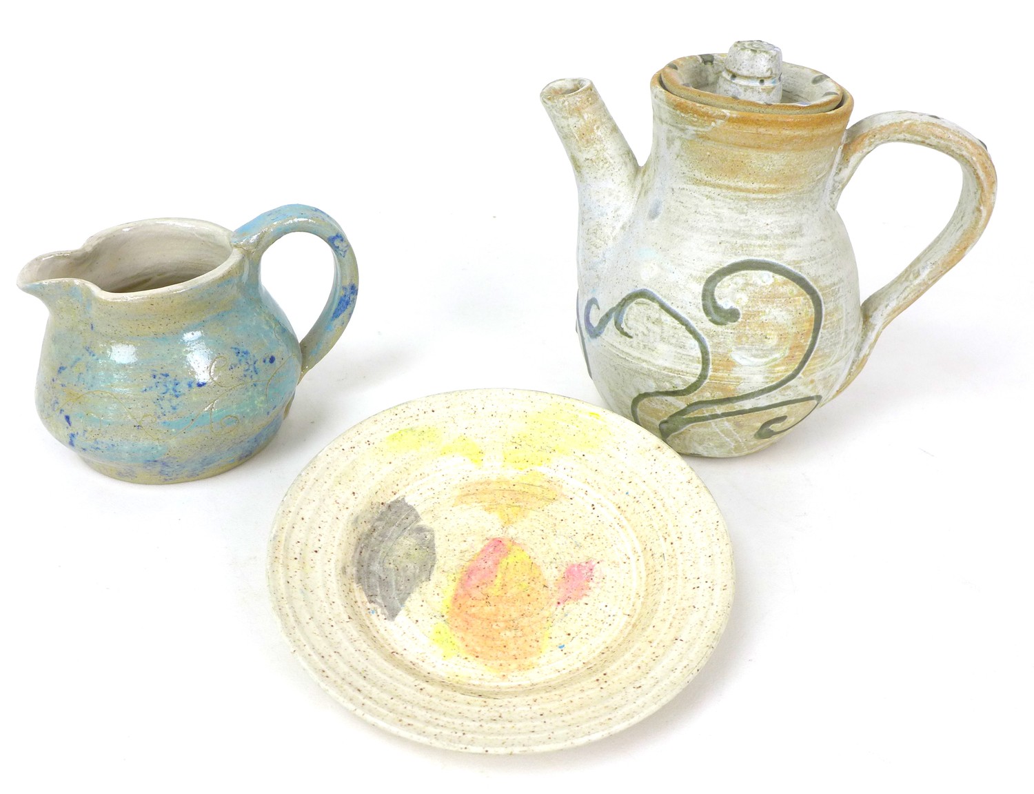 A 20th century studio pottery coffee pot, the cream on biscuit textured ground decorated with sky