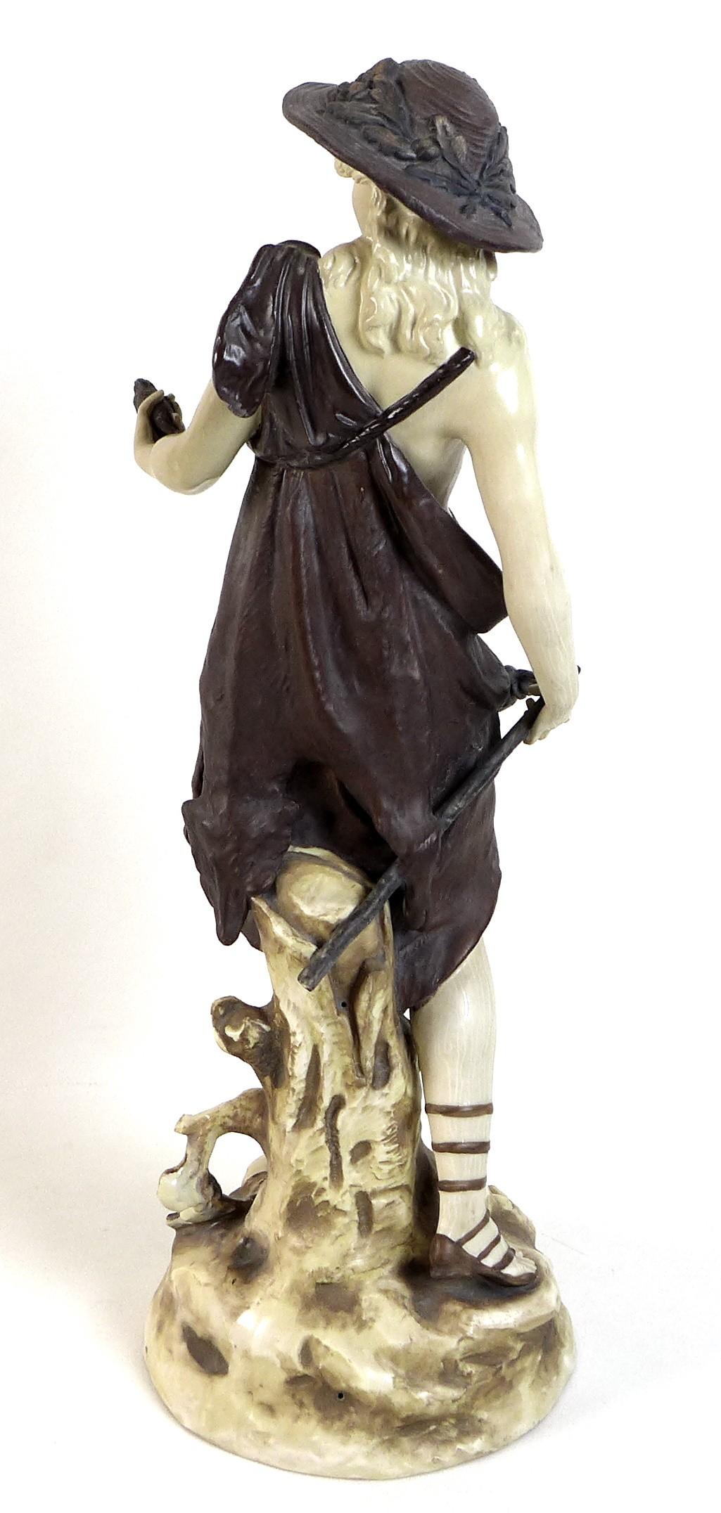 A Rudolstadt ivory porcelain figurine, modelled as a male dressed in a bear skin and carrying a - Image 3 of 4