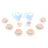 A 1950s Poole Pottery twin tone peach bloom and mist blue coffee set, pattern no. 'C100', comprising