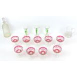 A collection of glassware, comprising nine cranberry glass champagne coups, 9.5 by 11.5cm high,