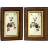 A pair of vintage painted mirrors, each painted with a basket of roses and forget-me-nots, hanging