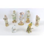 A group of seven continental porcelain and bisque figurines, comprising two porcelain cockatoos,
