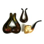 A Meerschaum pipe, the bowl modelled as a bearded gentleman wearing a turban, a further pipe with