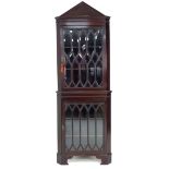 A Victorian Gothic style mahogany corner display cabinet, pointed arch pediment over two bevelled