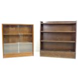 A vintage mahogany Herbert E Gibbs glazed bookcase, the two sliding glass doors enclosing two