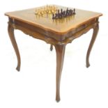 A late 20th century chess board and set on stand, with Staunton style pieces, the the stand with