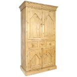 A pine cupboard, in Victorian style, with twin cupboard doors opening to reveal a single shelf, over
