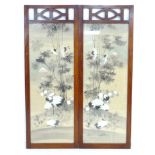 A mid century wooden screen, inset with a silk panel depicting cranes and bamboo with Mount Fuji