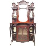 An Art Nouveau mahogany sideboard, with fluidly shaped top having two shelves to each side with ogee