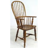 A 19th century oak Windsor chair, high rounded back with stick supports, H stretcher, turned legs,