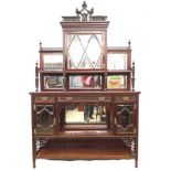 A Victorian mahogany sideboard the top with mirrored shelves flanking a central cupboard with