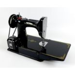 A vintage Singer Featherweight 221K1 portable electric sewing machine, Rotary Hook Reverse Feed,