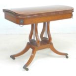 A George IV mahogany, crossbanded and ebony line inlaid card table, the fold over surface inset with