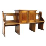 An unusual Victorian oak pew, with open back and shaped ends, fitted to its centre with a raised two