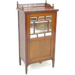 An Edwardian mahogany music cabinet, with pierced gallery, the door with nine inset bevelled