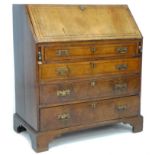 A George III mahogany bureau, inlaid decoration, fall front with fitted interior over four