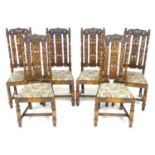 A set of six stained oak dining chairs, in Carolean style with heavily carved backs, the top rail