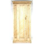 A Victorian pine cupboard, cornice over a single panel full length door with small metal handle,
