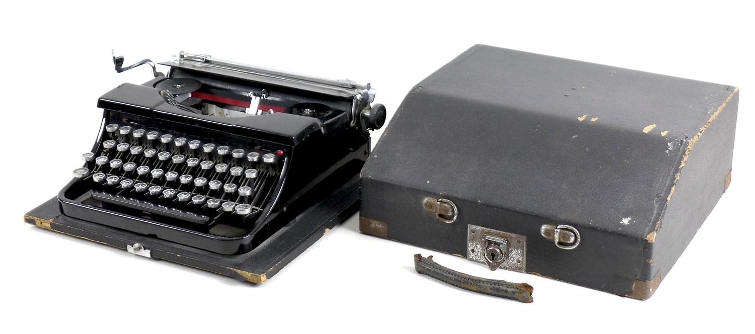 A vintage Blue Bird typewriter, with black finish, serial 302730, in black carry case.