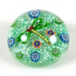 A Paul Ysart style paperweight, the mottled green ground with dragon fly to the centre with green