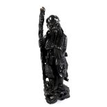 A Chinese hardwood carving of Shao Lao, Qing Dynasty, holding an ornately carved staff and a flaming